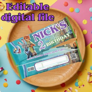May include: A teal and purple birthday party favor wrapper with the text "NICK'S 2ND BIRTHDAY". The wrapper features cartoon characters and the words "Editable digital file". The wrapper is on a wooden plate.