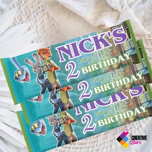 May include: Three birthday banner designs featuring characters from Zootopia. The banners have a teal background with images of a snake, Judy Hopps, and Nick Wilde. The text reads "Nick's 2nd Birthday". The banners have a green border.