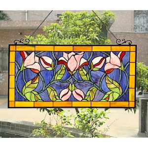May include: Rectangular stained glass window panel featuring pink and red flowers with green leaves against a blue background. The panel is framed in yellow and black, with a decorative black metal chain for hanging.
