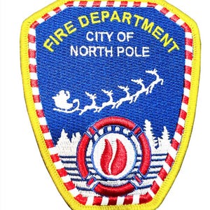 May include: Embroidered patch featuring the words "FIRE DEPARTMENT CITY OF NORTH POLE" in yellow. The patch has a blue background with a Santa and reindeer design. The patch has a red, white, and yellow border.