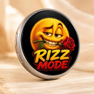 May include: A circular silver-toned object featuring a graphic of a fuzzy yellow emoji with a flirtatious expression, holding a red rose in its mouth. Below the emoji, the text RIZZ MODE is printed in bold yellow and red stylized lettering.