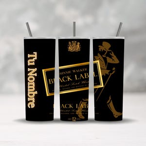 May include: Three black insulated tumblers with silver straws. One tumbler features the text "Tu Nombre" in gold. The other two tumblers display the Johnnie Walker Black Label logo in gold.