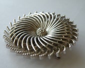 Trifari silver plated pinwheel brooch pin. Layered. Platinum Blondes or Trifari Blondes advertising
