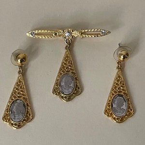 Clear glass cameo, clear rhinestone, filigree dangle, drop stud earrings and brooch. Set.