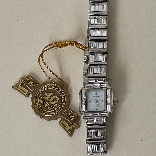 Oleg Cassini Swarovski clear crystals ,Japan quartz, MOP Mother of pearl dial,  steel  watch. 40 th Anniversary, 32-418