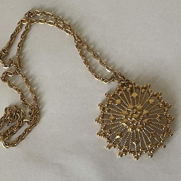 Monet gold plated starburst, atomic pendant necklace