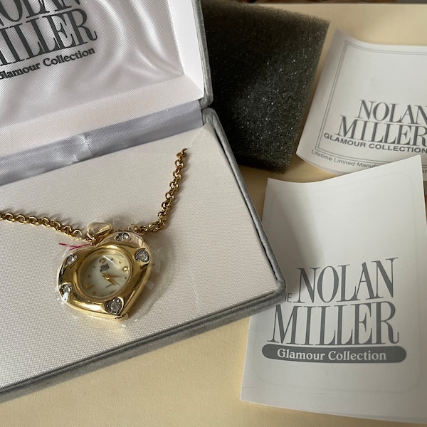 Nolan Miller gold plated Glamour Collection clear rhinestone heart pendant quartz watch with chain. Needs battery NOS