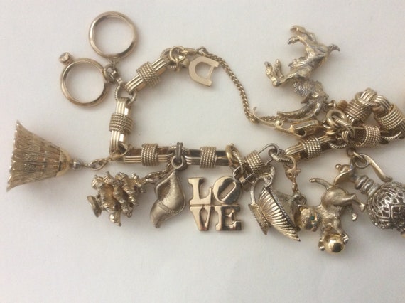 Monet 10 charm gold tone bracelet. Monet charms.