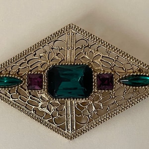 1928 unmarked large gold tone openwork scrollwork  Purple and Green Rhinestone Diamond Shaped Brooch