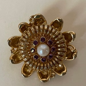 1928 unmarked flower brooch. Faux pearl, purple rhinestone.