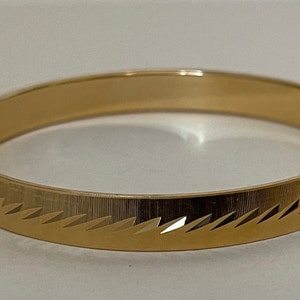 Monet gold plated brushed, textured, etched bangle bracelet. size S diameter 2 3/8&quot;
