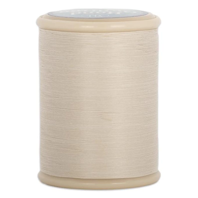 May include: A spool of off-white thread. The thread is tightly wound around a cylindrical core, with a smooth, even texture. The top and bottom of the spool are a light beige color. The thread is likely for sewing or crafting.