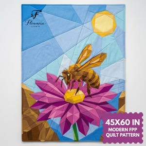 May include: A geometric quilt featuring a bee on a pink flower with a yellow center, under a yellow sun. The background is blue with geometric shapes. The quilt measures 45x60 inches. The quilt has the text "Floweria Studio".
