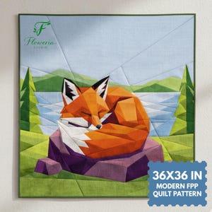 May include: A geometric quilt depicting a sleeping fox in orange, white, and black, on a purple rock. The background shows a lake, green trees, and a light blue sky. The quilt measures 91x91 cm and is a modern FPP quilt pattern.