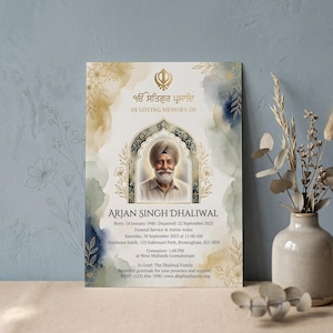 May include: A memorial card with a portrait of Arjan Singh Dhaliwal, framed by an ornate arch. The card features text in English and Punjabi, with floral and watercolor design elements in gold, blue, and beige.