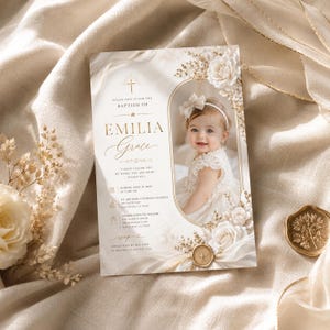 May include: A baptism invitation card featuring a photo of a baby in a white dress with a bow headband. The card includes gold text, a cross icon, and floral accents. Text reads: Please join us for the baptism of Emilia Grace, June 11, 2023.