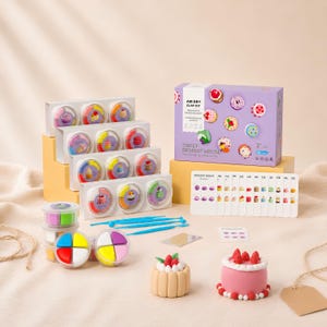 May include: An air dry clay kit titled Sweet Dessert House, featuring a purple box, multiple small containers of colored clay, blue sculpting tools, a white instruction card with dessert illustrations, and two finished clay cake models.