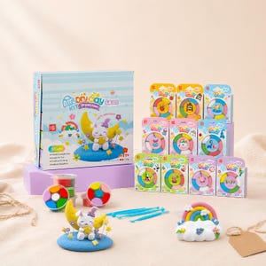May include: An air dry clay kit featuring a large box labeled Air Dry Clay Kit Dreamtoon with 60 colors. The set includes multiple small individual packaging boxes, round containers of colorful clay, blue sculpting tools, and two clay figures.