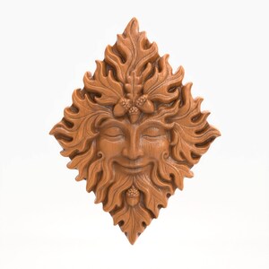 May include: A diamond-shaped, wooden carving of a Green Man face. The face has closed eyes, a smiling mouth, and a beard. The face is surrounded by leaves and topped with acorns. The carving is a warm brown color.