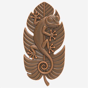 May include: A bronze gecko sculpture climbing a detailed leaf. The gecko has textured skin and is positioned vertically on the leaf, with its tail curled. The leaf has prominent veins and a detailed, naturalistic design.