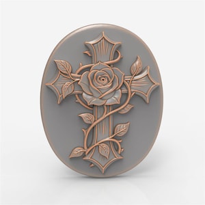 May include: A gray oval-shaped decorative piece featuring a cross design with a rose at the center. The cross and rose are detailed with a bronze-colored outline, and the rose is surrounded by vines and leaves.