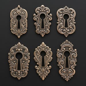 May include: Six antique bronze keyhole covers with ornate, swirling designs. Each cover features a keyhole shape in the center, surrounded by detailed scrollwork and decorative elements. The keyhole covers are arranged on a dark background.