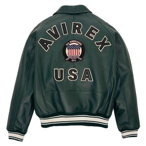 May include: A dark green leather bomber jacket with the word "AVIREX" arched across the upper back. Below the word "AVIREX" is a patch with the words "ALL AMERICANS" and "ESTABLISHED 1975" surrounding a US flag design. The word "USA" is below the patch.