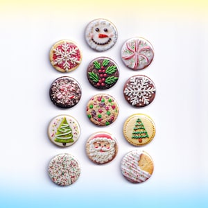 May include: A collection of festive Christmas cookies, each round and decorated with holiday-themed designs. Frosting details include a snowman face, snowflakes, Christmas trees, Santa Claus, and candy canes. Sprinkles and colorful accents add to the cheerful, seasonal appearance.