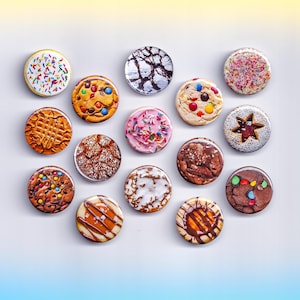 May include: A collection of round cookie-themed magnets with various designs. Some magnets feature sprinkles, chocolate chips, and icing. Others have intricate patterns and textures, showcasing a variety of colors and styles.