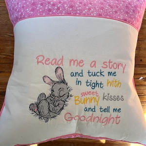 Soft pillow with a front pocket to hold a child&#39;s book.  The pillow is machine embroidered with a sweet bunny.