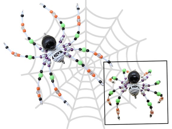 A one-of-a-kind hand-beaded mummy spider ornament — genuinely OOAK gothic craft you'd never find at a big-box store.