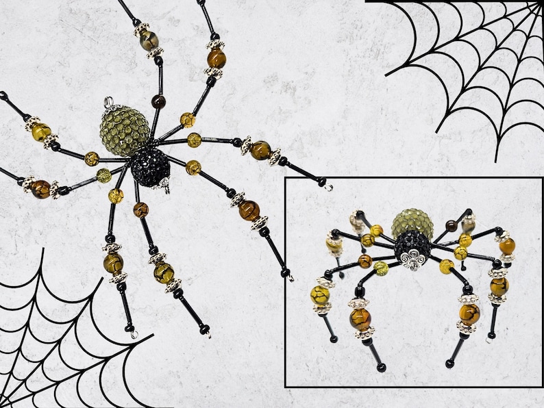 May include: A decorative spider ornament featuring a green crystal-encrusted abdomen and a black crystal-encrusted thorax. The eight legs are constructed from black wire accented with amber-colored beads and silver-toned metal spacers.