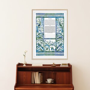 May include: A framed blue and green ketubah with a floral design and birds. The ketubah is a Jewish marriage contract.