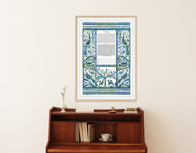May include: A framed blue and green ketubah with a floral design and birds. The ketubah is a Jewish marriage contract.