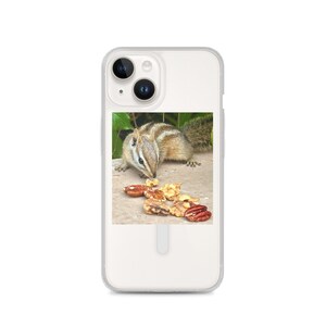 May include: A clear phone case featuring a photo of a chipmunk eating nuts. The chipmunk has brown and tan fur with stripes. The nuts are various shades of brown and tan. The background is green.