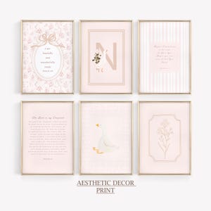May include: Six framed prints with gold frames. The prints feature soft pink and white designs, including floral patterns, a goose, and inspirational text. The text includes "I am fearfully and wonderfully made" and "The Lord is my Shepherd". The bottom of the image reads "Aesthetic Decor Print".