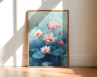 May include: A framed watercolor painting of lotus flowers. The artwork features pink and white lotus blossoms with yellow centers, set against a blue and teal background. The painting is in a wooden frame and leans against a white wall.
