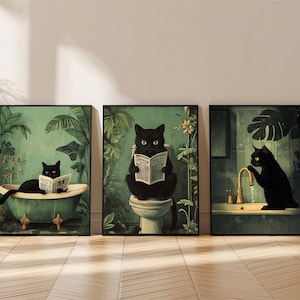 May include: Three framed art prints depict black cats in a bathroom. One cat is in a bathtub, another reads on a toilet, and the third interacts with a tap. The artwork has a vintage, botanical theme with a green and gold colour palette.