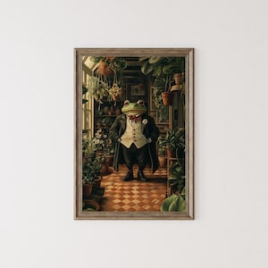 May include: A framed art print featuring a dapper frog in a suit and bow tie, standing in a greenhouse filled with potted plants. The frog has green skin and red-rimmed eyes. The artwork has a vintage, whimsical style.