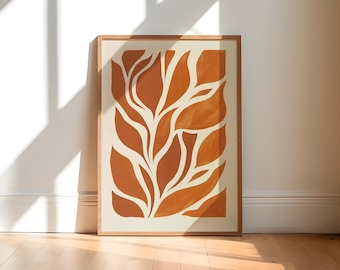 Peut inclure: Une affiche encadrée présentant un design botanique abstrait. L'œuvre d'art met en valeur des formes de feuilles orange-brun stylisées sur un fond crème. Le cadre en bois complète la palette de couleurs chaudes, créant une esthétique moderne et minimaliste.