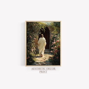 May include: A framed print featuring a figure in a white robe walking towards a dark doorway. The path is lined with lush greenery and pink roses. The text "Aesthetic Decor Print" is at the bottom.