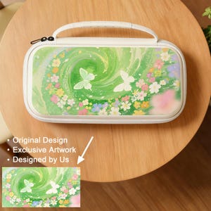 May include: A white carrying case with a handle, featuring a vibrant green and white floral design with butterflies. The case has a zipper closure and a white handle. The artwork includes colorful flowers and a swirling green background.