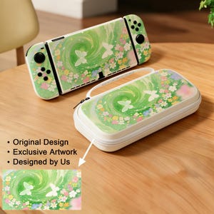 May include: A green and white Nintendo Switch console and matching carrying case. The design features a swirling green pattern with white butterflies and colorful flowers. The case has a white zipper and handle.