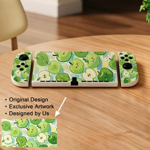 May include: A white Nintendo Switch console featuring a green apple pattern. The console has two controllers, each with a matching apple design. The apple design is repeated on the console and controllers. The image text reads "Original Design", "Exclusive Artwork", and "Designed by Us".