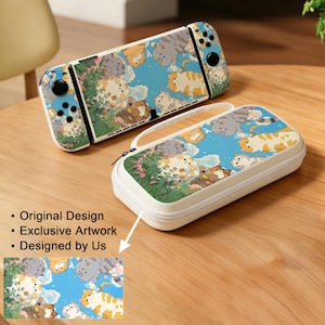 May include: A portable gaming console and a matching rectangular carrying case, both featuring a light blue sky background with various illustrated cats and green foliage. The console has black buttons and joysticks on the side controllers.