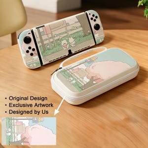 May include: A cream-colored Nintendo Switch console and matching carrying case. Both feature a whimsical illustration of a cartoon scene with characters, trees, and a pink cloud. The case has a white zipper and handle.