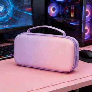 May include: A lavender and pink carrying case with a handle, designed for electronics. The case has a zipper closure and is sitting on a pink desk. The background includes a computer monitor, keyboard, and computer tower.