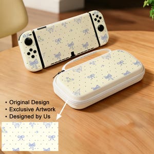 Może przedstawiać: Kremowa konsola Nintendo Switch i etui, oba ozdobione powtarzającym się wzorem niebieskich kokardek, motyli i czarnych kropek. Etui ma biały zamek błyskawiczny i uchwyt. Tekst na zdjęciu brzmi "Original Design", "Exclusive Artwork" i "Designed by Us".