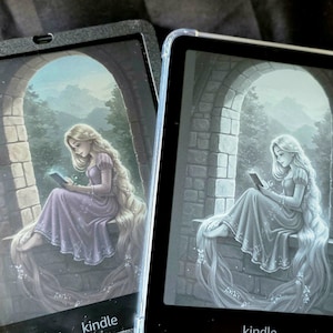 May include: Two Kindle e-readers with a fantasy illustration of a woman with long blonde hair reading. The woman is seated in a stone archway, wearing a purple dress. The word "kindle" is visible at the bottom.