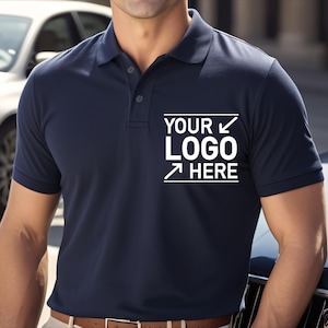 May include: Navy blue polo shirt with a three-button placket and a collar. The shirt features the text "YOUR LOGO HERE" in white, within a white rectangle. The shirt is made of a smooth fabric.